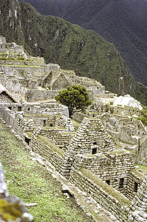Oval Temple of the Sun (center) of Machu Picchu seen from above. Peru.