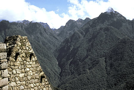 Roofline mimics surrounding mountains (projecting stone posts to tie down roof) in Machu Picchu. Peru.