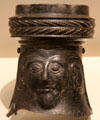 Etruscan black ceramic Bucchero Ware broken-off top of jug with male mask at Royal Ontario Museum. Toronto, ON.