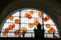 Flowerlike glass sculpture by Dale Chihuly in arched window of Tacoma Union Station. Tacoma, WA.