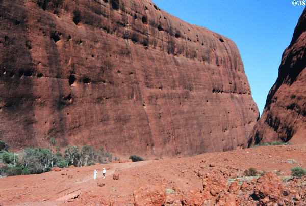 Massive size of The Olgas dwarfs two hikers. Australia.