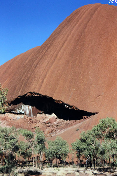 Overhanging mouth of a cave at base of Uluru (aka Ayers Rock). Australia.