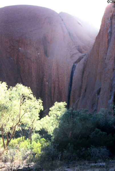 Sun shines over saddle of Uluru (aka Ayers Rock). Australia.