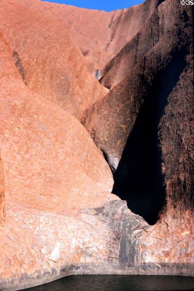 Pond under water sculpted rocks of Uluru (aka Ayers Rock). Australia.
