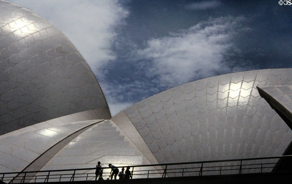 Walking across a bridge near roof of Sydney Opera House. Sydney, Australia.