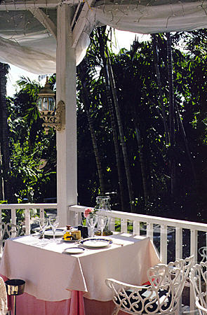 Dining area looking out onto garden of Graycliff House. Nassau, The Bahamas.