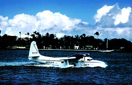 Sea plane makes a water landing harbor. The Bahamas.