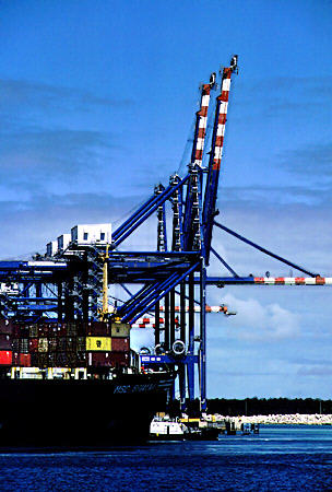 Cranes & container ship in Freeport harbor. The Bahamas.
