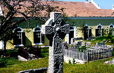 Wesley Church (1843) with Celtic cross in graveyard in Harbour Island. The Bahamas.