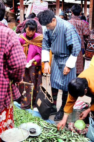 People in national dress buy beans at Thimpu's Saturday market. Bhutan.