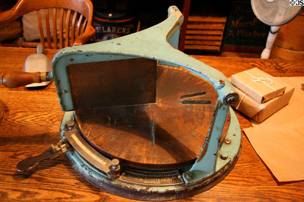 Antique cheese cutter (1901) in heritage general store at Burnaby Village Museum. Burnaby, BC.