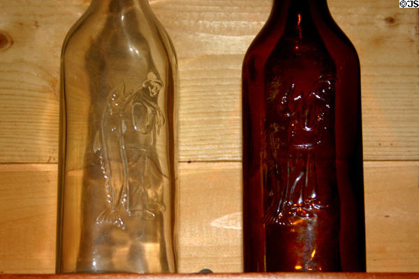 Two antique liquor bottles embossed with fisherman with large fish at Hudson Oddities. NB.