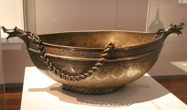 Engraved brass beggar's bowl (Kashkul) (late16thC) from Iran at Aga Khan Museum. Toronto, ON.