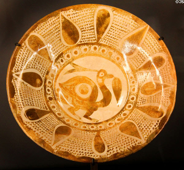 Earthenware dish with luster painting of bird (9th-10thC) from Iran at Aga Khan Museum. Toronto, ON.