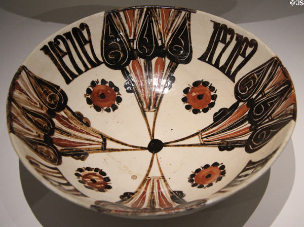 Earthenware bowl with underglaze slip-painting with Arabic word for piety around four points of compass (10th-11thC) from Khorasan, Iran at Aga Khan Museum. Toronto, ON.