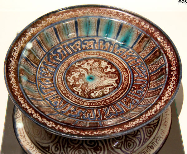 Fritware bowl painted blue & brown with bird & Arabic script (14thC) from Iran at Aga Khan Museum. Toronto, ON.