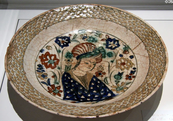 Fritware dish with underglaze painting of court character (early 17thC) from Iran at Aga Khan Museum. Toronto, ON.