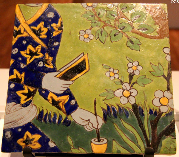 Earthenware tile with over-glaze painting of section of man writing (17thC) from Iran at Aga Khan Museum. Toronto, ON.
