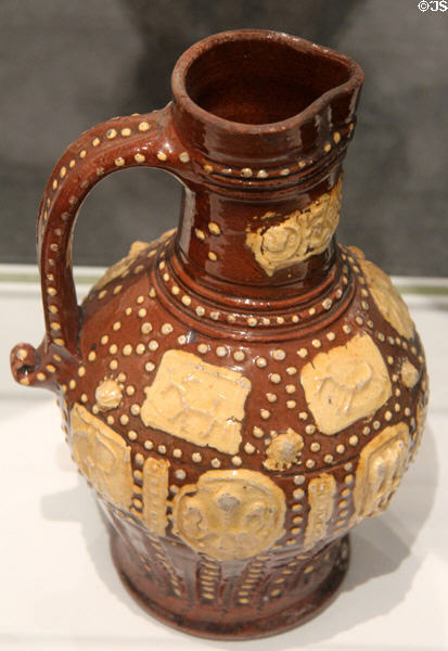 Earthenware brown & yellow jug (1687) attrib. George Richardson of Wrotham in Kent at Gardiner Museum. Toronto, ON.