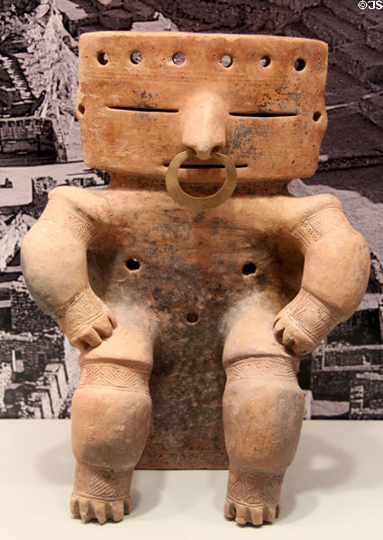 Quimbaya earthenware seated figure with gold nose ring (1000-1400) from Colombia at Gardiner Museum. Toronto, ON.