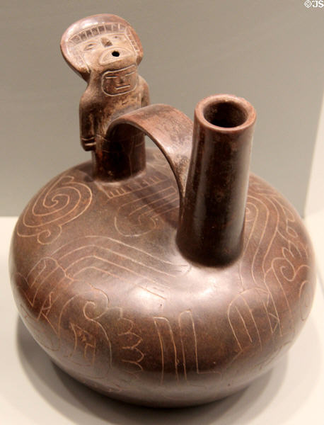 Chavin culture earthenware whistling bottle with bridge handle (900-100 BCE) from Tembladera, North Coast Peru at Gardiner Museum. Toronto, ON.