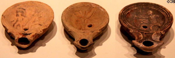 Roman clay oil lamps with gladiator images (c50 CE) from Italy & middle east at Royal Ontario Museum. Toronto, ON.