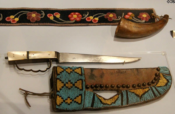 Plains Cree or Ojibway powder horn on beaded strap (c1875) plus Alberta Blackfoot knife & beaded sheath (c1875) at Royal Ontario Museum. Toronto, ON.