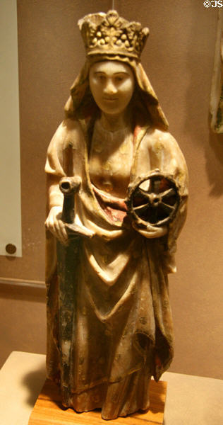 St Catherine of Alexandria with her spiked torture wheel & sword symbols alabaster sculpture (late 1400s) from Nottingham, England at Royal Ontario Museum. Toronto, ON.