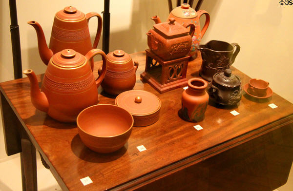 English & Bohemian red stoneware vessels (19thC) atop Mahogany veneered English table (c1870-1900) at Royal Ontario Museum. Toronto, ON.