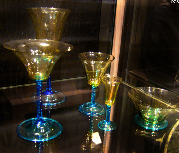 Steuben glass goblet collection in transparent amber on celeste blue stems (c1920) by Frederick Carder of Corning, NY at Royal Ontario Museum. Toronto, ON.