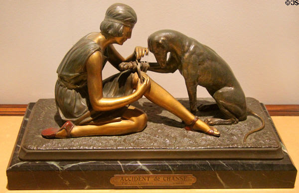 Art Deco polychromed bronze sculpture accident during the hunt with woman bandaging dog (1920s) from Boise, France at Royal Ontario Museum. Toronto, ON.