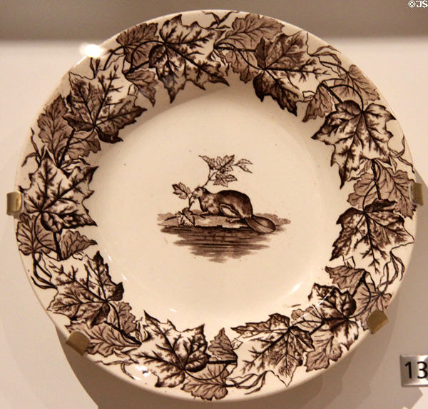 Ironstone plate with brown transfer-print of Canadian beaver ringed by maple leaves (c1880) from England at Royal Ontario Museum. Toronto, ON.