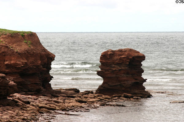Eroded pinnacles in surf at North Cape. PE.