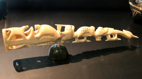 Inuit carved walrus tusk with hunting scene (c1949) by Levi Nunngaq of Resolute Bay at Montreal Museum of Fine Arts. Montreal, QC.