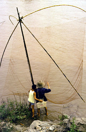 Fisherman using ancient style net on Yangtze (Yangtse) River in Fengdu. China.