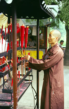 Monk lights candles at Big Wild Goose Pagoda in Xi'an (Xian). China.
