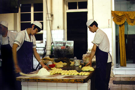 Cooks prepare food at a noodle restaurant in Lanzhou. China.