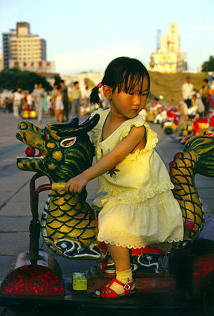 Child rides a dragon in Lanzhou. China.