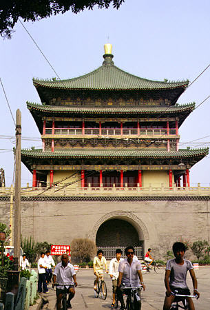 Bicyclists in front of a bell tower in Xi'an. China.