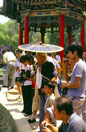 Visitors with parasols visiting the Xi'an hot springs. China.