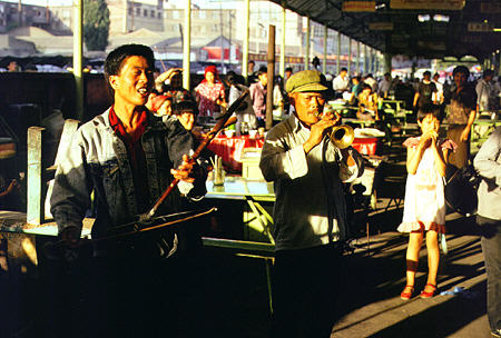 Musicians play along streets of Urumqi. China.