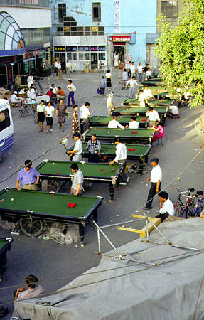 Playing pool outdoors in Urumqi (Urumchi). China.