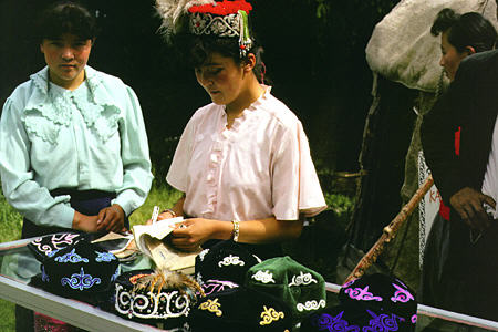 Women selling colorful hats in Uighur village near Urumqi. China.