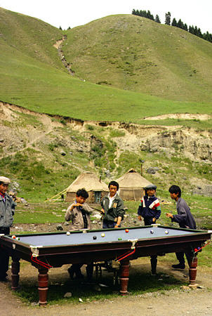 Playing pool outdoors in Uighur village in southern pasture area near Urumqi (Urumchi). China.