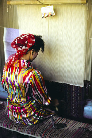 Woman weaves at a carpet factory in Kashgar. China.