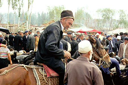 Man on a horse at the Sunday market in Kashgar. China.
