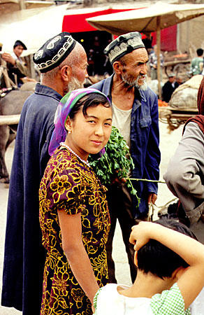 Woman and her child at Sunday market in Kashgar. China.