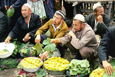 Selling a small variety of fruits and vegetables at Kashgar's Sunday market. China.