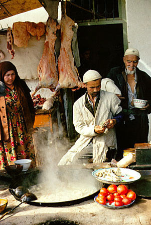 Preparing food to sell during Sunday market in Kashgar. China.