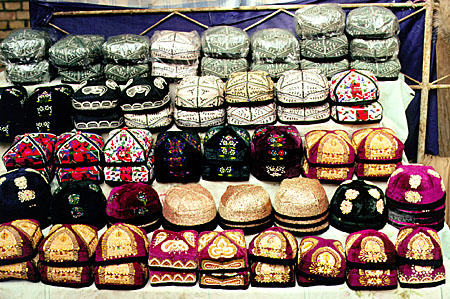 Variety of colorful and decorative hats for sale at the Kashgar Sunday market. China.